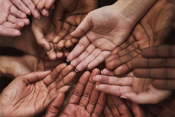 Shot of a group of hands held cupped out together